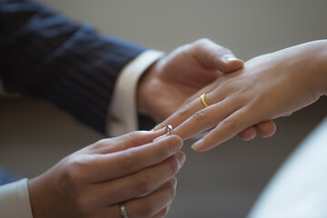 Obraz na płótnie Canvas Wearing rings for each other at the wedding