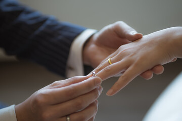 Obraz na płótnie Canvas Wearing rings for each other at the wedding