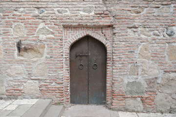Fototapeta na wymiar Wrought iron door. metal door in an old medieval temple. medieval background