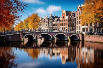 Amsterdam with its gabled houses mirrored in the calm canal, framed by trees showing their vibrant fall foliage
