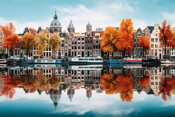 Photo sur Plexiglas Amsterdam Amsterdam with its gabled houses mirrored in the calm canal, framed by trees showing their vibrant fall foliage