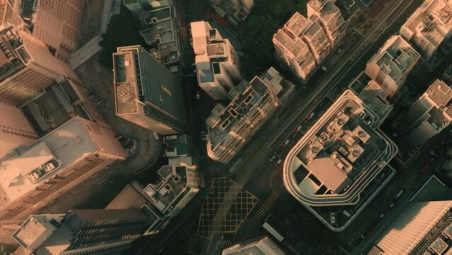 AERIAL. Cinematic video and Top view of Hong Kong city center at sunset and sun light.