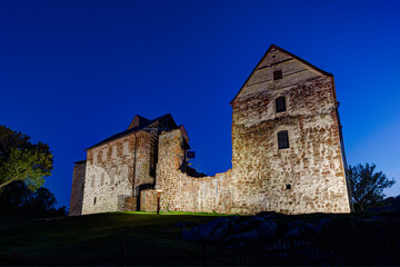 Lit medieval Kastelholm Castle in Åland Islands, Finland, at dusk in the summer.