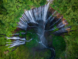 Aerial top view from above of Tumpak Sewu ,also known as Coban Sewu, 120m high waterfall in Malang regency, East Java, Indonesia - 631702035