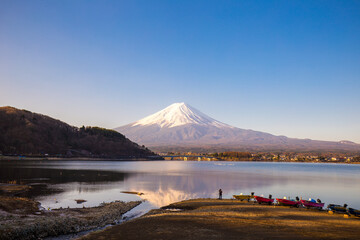 Fujisan mountain reflection on water with boat morning sunrise  kawaguchiko lake snow landscape