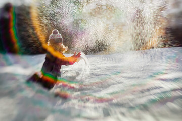 8 years old girl throwing snow in the air in a winter backyard scene