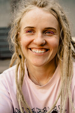 Young happy woman with dreadlocks smiling, portrait, close-up.