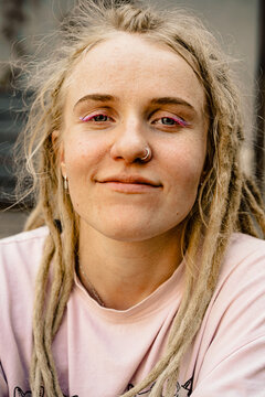Young happy woman with dreadlocks smiling, portrait, close-up.
