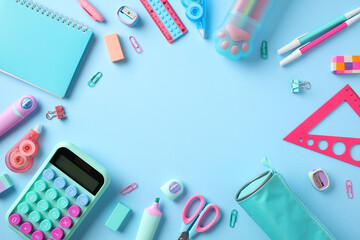 Back to school concept. Flat lay composition with school supplies on pastel blue background.