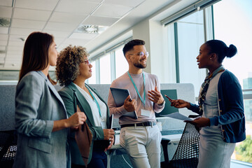 Multiracial business team communicating while working in office.