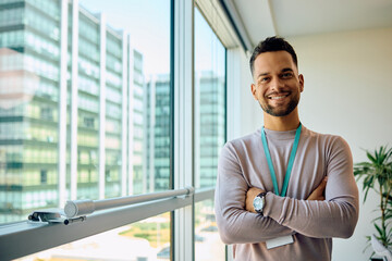 Portrait of young confident businessman in office looking at camera.