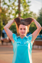 Portrait of a young beautiful girl in a summer park.