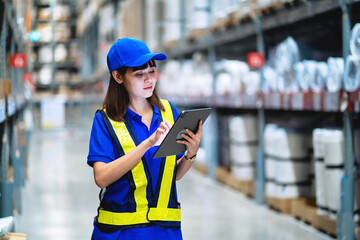 Female worker working in a warehouse Check and analyze the product. Logistics concept and working...