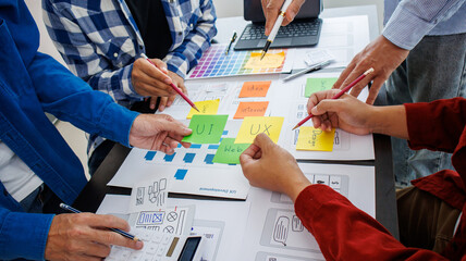 Close-up ux developers and ui designers use augmented reality to brainstorm on mobile app interface...