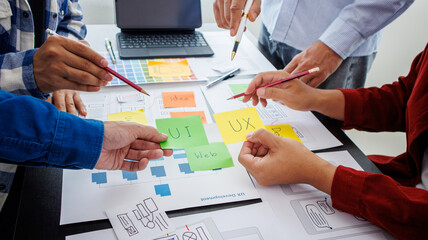 Close-up ux developers and ui designers use augmented reality to brainstorm on mobile app interface...