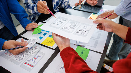 Close-up ux developers and ui designers use augmented reality to brainstorm on mobile app interface...