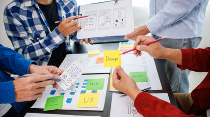 Close-up ux developers and ui designers use augmented reality to brainstorm on mobile app interface...