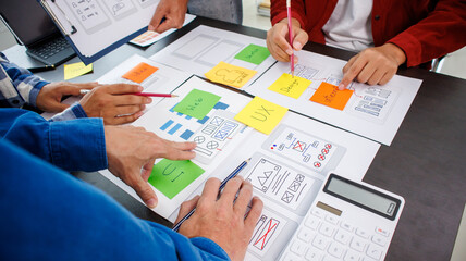 Close-up ux developers and ui designers use augmented reality to brainstorm on mobile app interface...