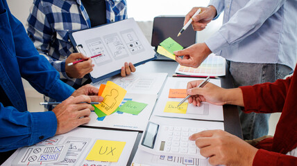 Close-up ux developers and ui designers use augmented reality to brainstorm on mobile app interface...