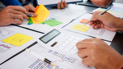 Close-up ux developers and ui designers use augmented reality to brainstorm on mobile app interface...