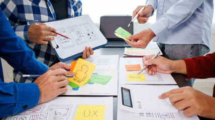 Close-up ux developers and ui designers use augmented reality to brainstorm on mobile app interface...