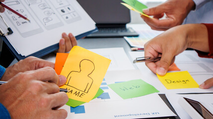 Close-up ux developers and ui designers use augmented reality to brainstorm on mobile app interface...