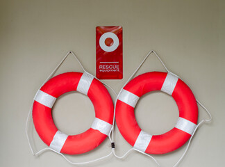 Two white red lifebuoy hanging on grey background. concept rescue equipment and safety