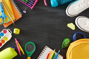 Explore the realm of education. Top view composition of educational tools, backpack, pair of shoes,...