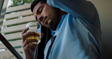 A businessman drinking alcohol to relieve depressed and stressed with problems in his life.