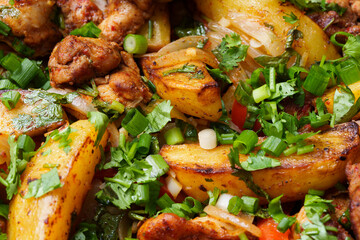 Baked potatoes with meat and fresh herbs close-up