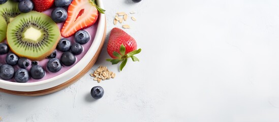 Make a smoothie bowl with Pink Berry, topped with granola, kiwi, and blueberries. The background is light gray, and space for adding text.