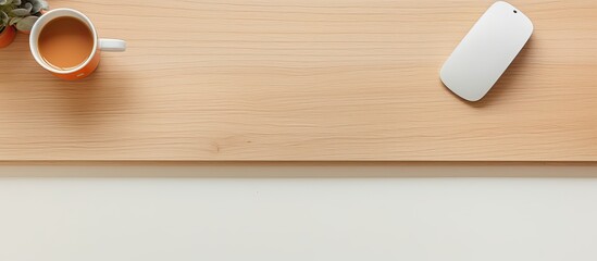 A top-down view of an office desk with a computer mouse, keyboard, coffee cup, and supplies. empty space available for adding text or other elements.