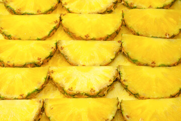Pineapple juicy yellow slices as a background.