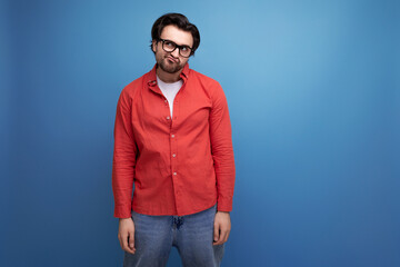 attractive 35 year old brunette millennial man with gorgeous hair in a red shirt