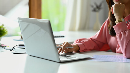 Cropped shot of female investment advisor chatting with client online, communicating on internet via laptop computer.