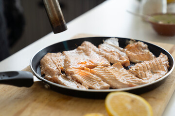 Japanese Chef sprinkle salt on salmon meat. Japanese Cuisine food, using gas burner torch.