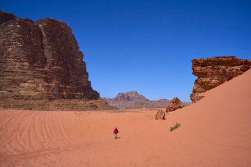 A tourist walking through the desert. Wadi Rum Desert in Southern Jordan