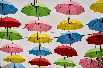 colorful umbrellas hang above the streets of Jerusalem