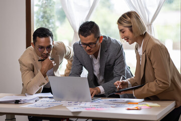 Group of confident business people point to graphs and charts to analyze market data, balance sheet, account, net profit to plan new sales strategies to increase production capacity.	