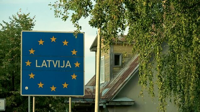 static wide shot of Latvian border sign