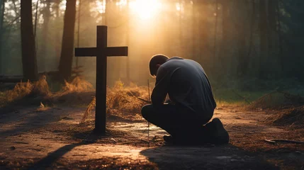 Foto op Plexiglas An emotive photo of a person kneeling in prayer before a Christian cross, finding solace in devotion Generative AI © Denis Yevtekhov