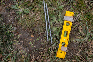 Fototapeta premium two large steel nails together with a hand level, archeological works