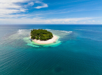 Aerial view of white sand beach with coconut trees. Corals on the beach. San Victor Island. Mindanao, Philippines. Travel concept.