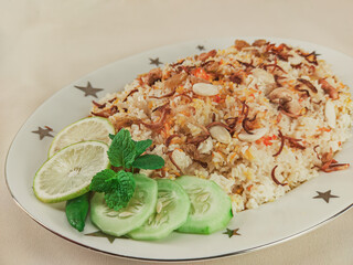A traditional rice dish Pilaf or pilau is homemade and decorated with chicken roast..