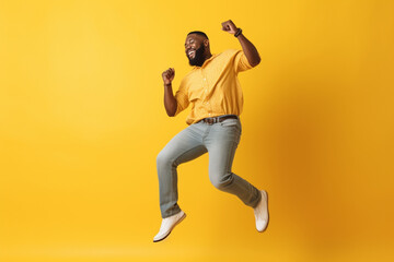 Fototapeta na wymiar Happy relaxed black man dancing against yellow background, having fun on party