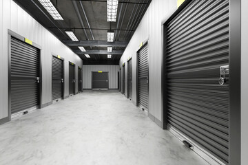 Self storage. Warehouse corridors with black gates. Doors to self storage are closed. Warehouse...