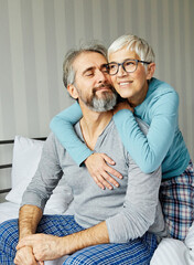 couple senior bed woman man home wife husband love together elderly caucasian adult happy retirement mature male old bedroom smiling resting retired aged relaxation leisure lying relationship