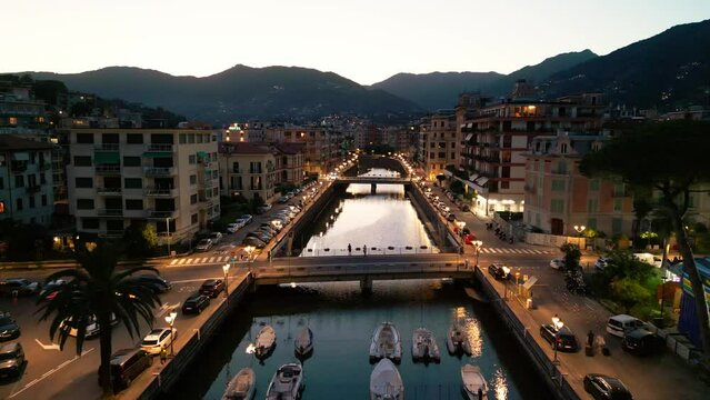 night city lights, city ​​of italy in the light of lanterns, warm light, yachts on the canal, ships in the pier, nightlife, Italy Rapallo