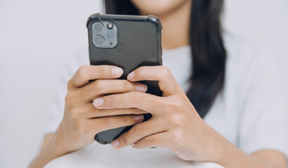 Young adult happy smiling Hispanic Asian student wearing headphones talking on online chat meeting using laptop in university campus or at virtual office. College female student learning remotely.