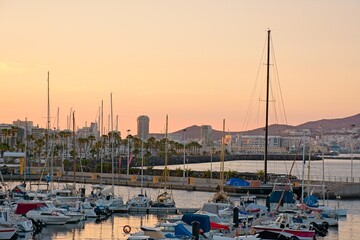 Boats in the harbor during sunset at Big Canary Sports Dock (Muelle Deportivo de Las Palmas), Las Palmas de Gran Canaria, Spain - obrazy, fototapety, plakaty